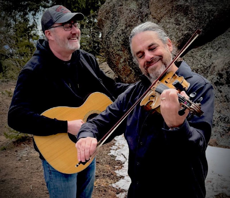 Blood Brothers duo: Lance and Jay Blood Brothers duo: Lance on guitar and Jay on fiddle among mountain boulders